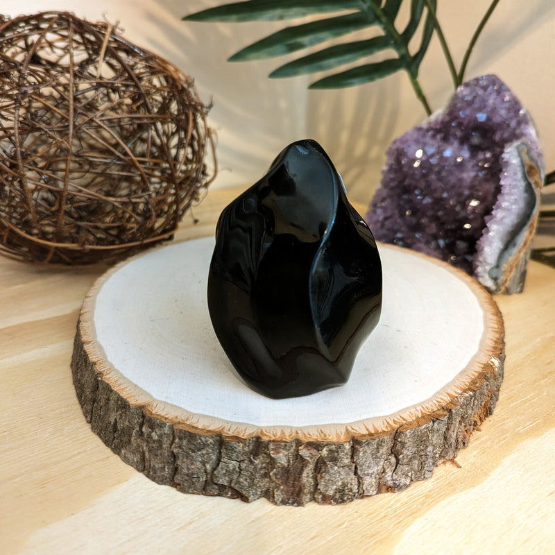 Beautiful and vibrant Obsidian Flame Crystal, a naturally occurring volcanic glass known for its dark body color and glassy luster. This powerful gemstone, symbolizing protection and truth, is celebrated for its healing properties and deep connection to the root chakra. Originating from volcanic eruptions around the world, the Obsidian Flame Crystal is an embodiment of natural beauty and spiritual resonance, making it a remarkable addition to any collection."