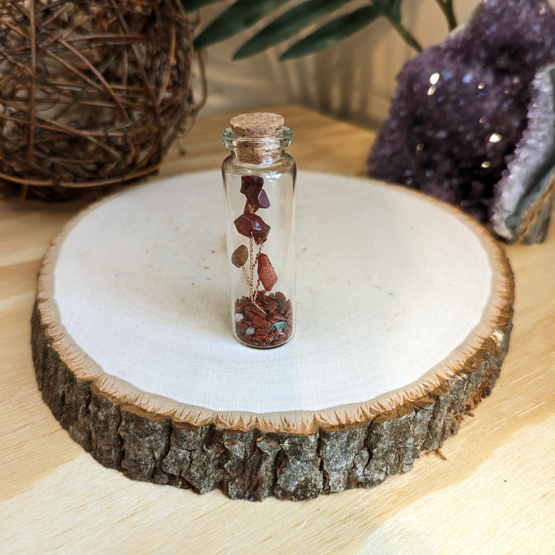 Handmade Red Jasper Crystal Tree Wishing Bottle for Chakra Healing, Anxiety Relief, and Positive Energy. Perfect for beginners exploring crystal healing or seasoned users of healing stones and crystals. Red Jasper, a grounding stone connected to the Earth element, is prominently displayed in this unique piece.