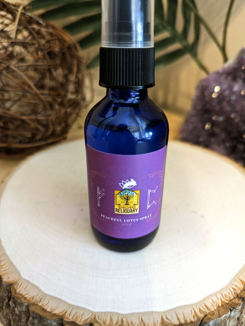 Person holding a bottle of Peaceful Lotus Aura Spray, ready to mist above face and shoulders. This product promotes deep peace, calm, and confidence with its blend of organic essential oils and flower essences.
